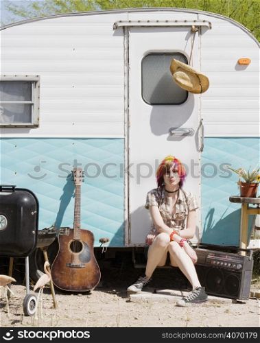 Woman outside caravan