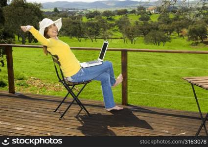 Woman outside on a laptop
