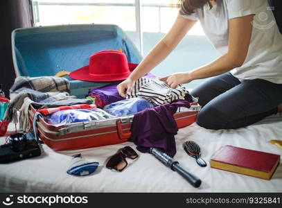 Woman packing suitcase on bed for a new journey packing list for travel planning preparing vacation Book Now Traveling Transportation 