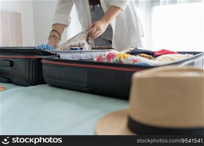 Woman packing suitcase on bed for a new journey packing list for travel planning preparing vacation Book Now Traveling Transportation.