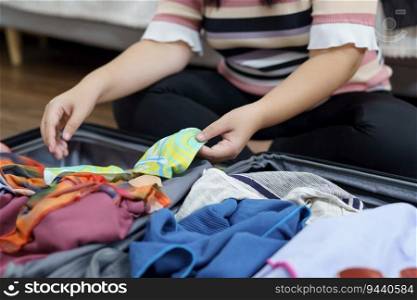 Woman packs baggage in suitcase for new journey packing a luggage travel plans vacation.