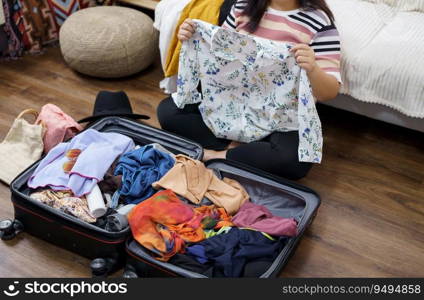 Woman packs baggage in suitcase for new journey packing a luggage travel plans vacation.