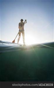 Woman paddleboarding on ocean