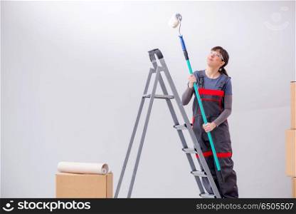Woman painter painting in new apartment