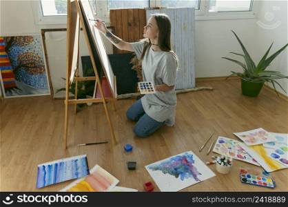 woman painter sitting floor