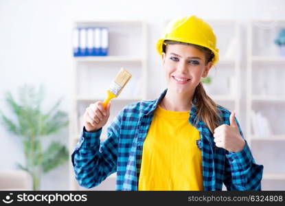 Woman painter with paintbrush in workshop