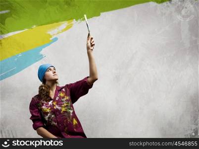 Woman painter. Young woman painter in bandana with paintbrush in hand