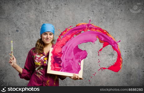 Woman painter. Young woman painter with palette and brush