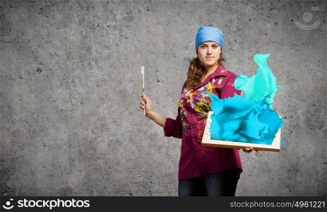 Woman painter. Young woman painter with palette and brush