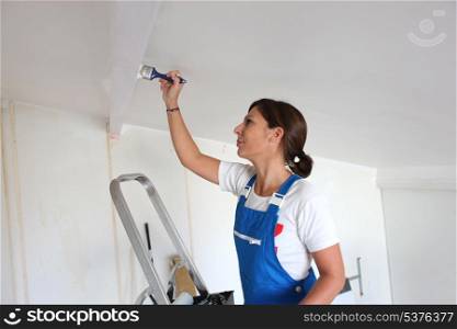 Woman painting a ceiling