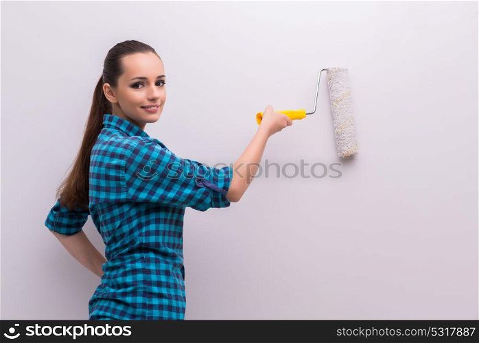 Woman painting house in DIY concept