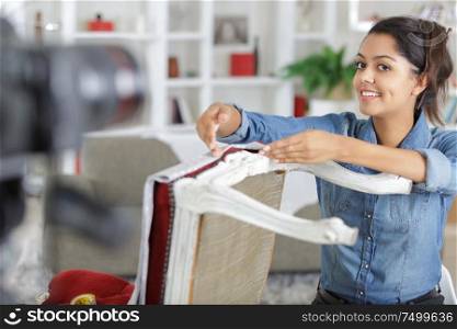 woman painting renewing chair at home