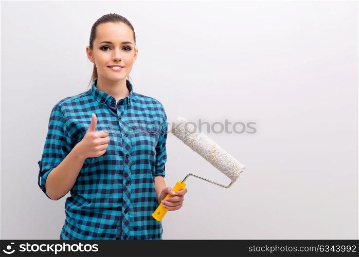 Woman painting the wall in DIY concept