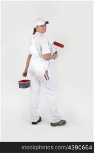 Woman painting wall red