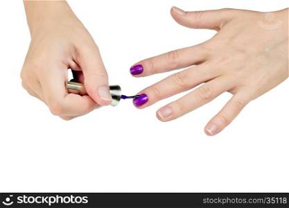 Woman paints fingernails purple varnish