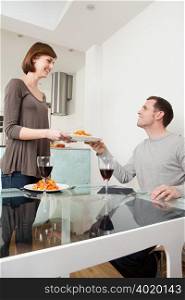 Woman passing plate to husband