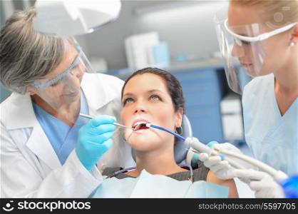 Woman patient dental check open mouth professional dentist team