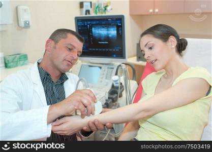 woman patient having a wrist ultrasound