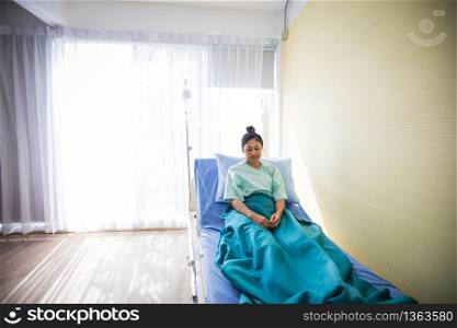 Woman patient sitting on a doctor lying in bed at Hospitals