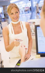 Woman paying for purchases with credit card