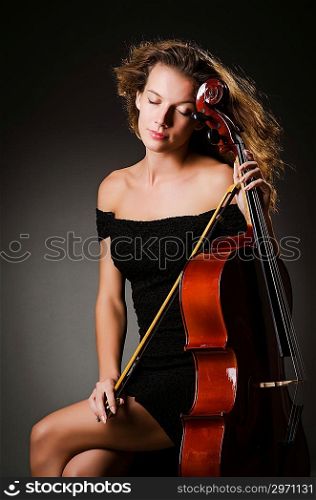 Woman performer with cello in studio