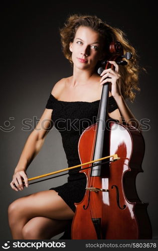 Woman performer with cello in studio