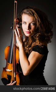 Woman performer with violin in studio