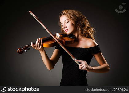 Woman performer with violin in studio