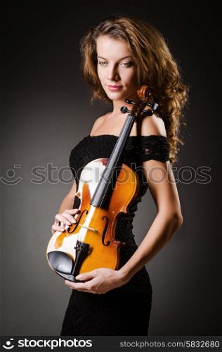 Woman performer with violin in studio