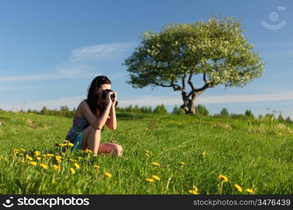 woman photographer on green grass field