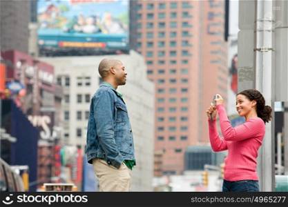 Woman photographing man