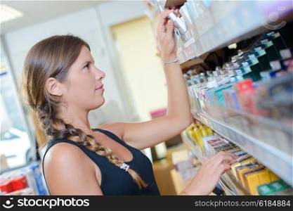woman picking a product from the shelf