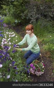 Woman picking flowers in garden