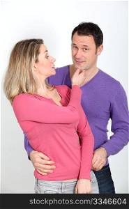 Woman pinching her boyfriend&acute;s chin