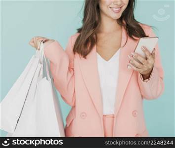 woman pink jacket smiling smartphone