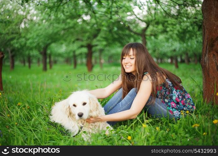 Woman play with her dog - golden retriever in the park