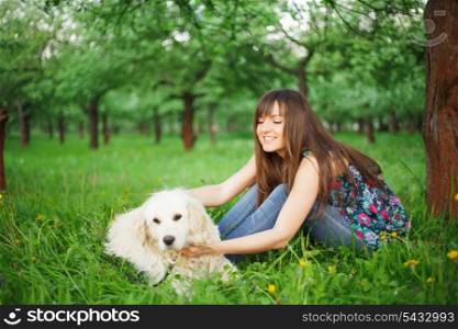 Woman play with her dog - golden retriever in the park
