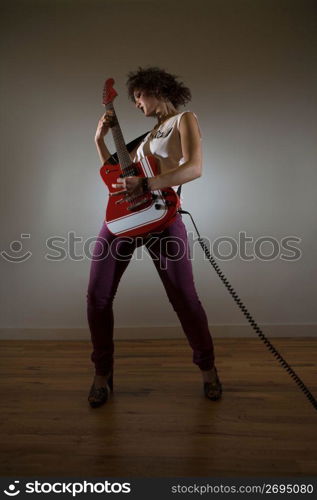 Woman playing an electric guitar