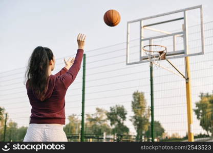 woman playing basketball alone with copy space 2