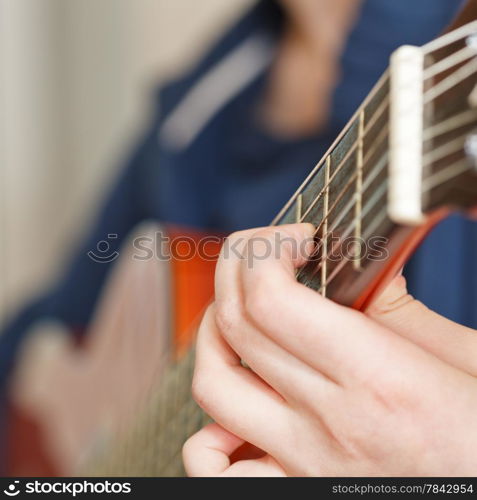 woman playing classical acoustic guitar close up
