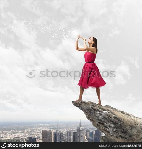 Woman playing fife. Young pretty woman in red dress playing flute