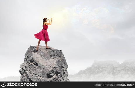 Woman playing fife. Young woman in red dress wearing blindfold and playing fife