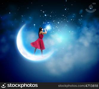 Woman playing flute. Young woman in red dress standing on moon and playing fife