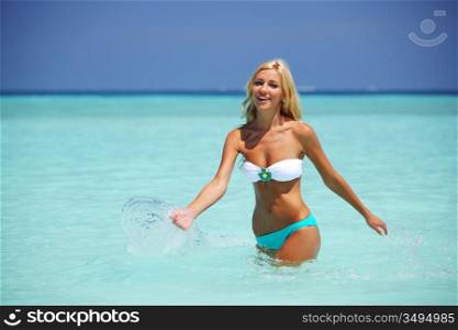 woman playing in ocean water