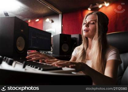 woman playing keyboard feeling music