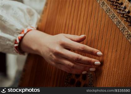 Woman playing on ethnic traditional ukrainian instrument bandura or pandora. High quality. Woman playing on ethnic traditional ukrainian instrument bandura or pandora