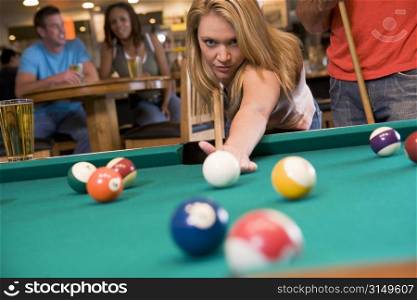 Woman playing pool