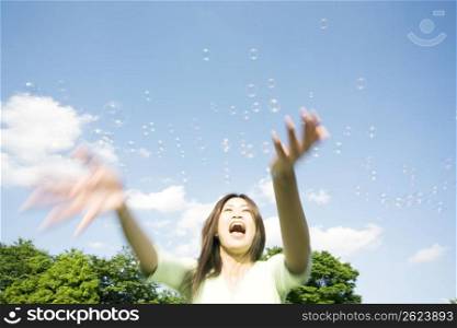 Woman playing soap bubbles