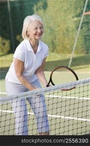 Woman playing tennis and smiling