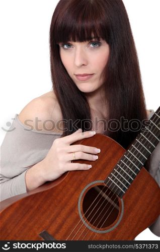 Woman playing the acoustic guitar